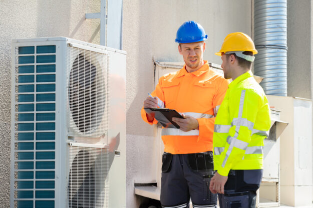 An Electrician Men Checking Air Conditioning Unit HVAC Systems