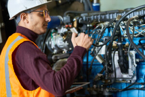 heavy equipment maintenance checking for leaks