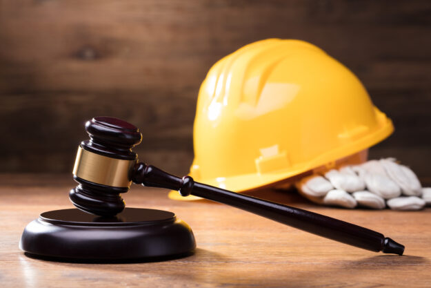 Gavel In Front Of Yellow Safety Helmet New HVAC regulations for 2023
